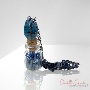 Blue and Gunmetal Cross Bottle Necklace