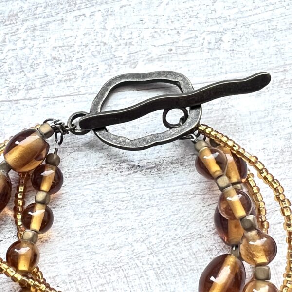 Gold Glass Bronze Four-Strand Bracelet and Earrings